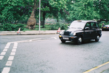 A London cab passing Coram’s Fields, London